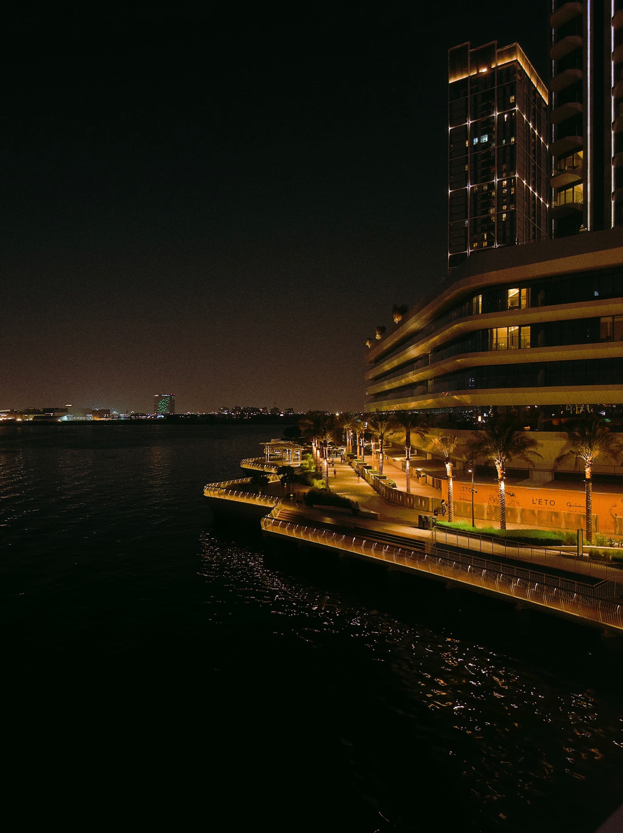 Lights whisper over still water